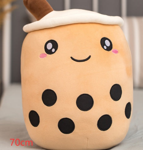 Tan plush milk tea cup pillow with brown straw and white top, smiling face and dark bubble spots
