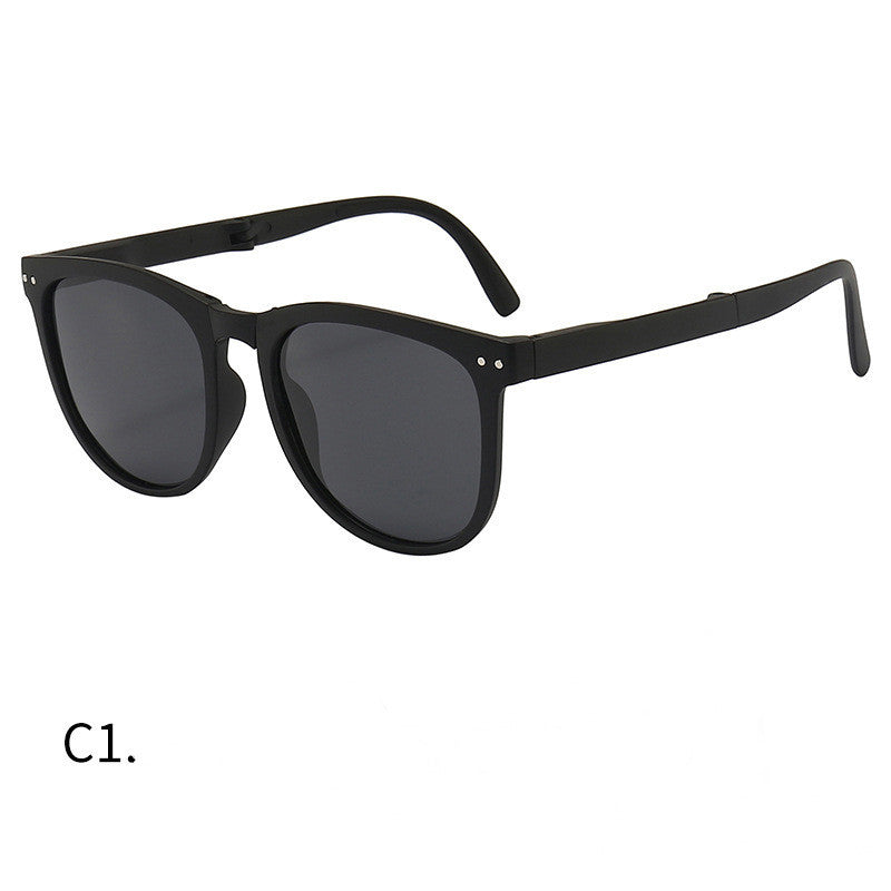 Foldable sunglasses with black frames and dark lenses