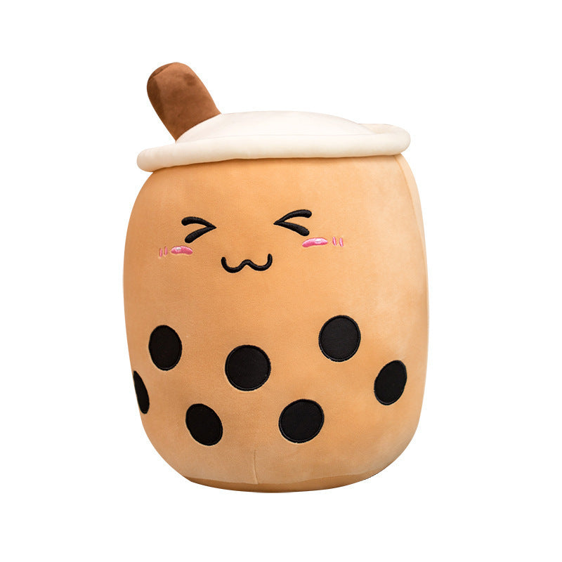Tan plush bubble tea cup pillow with brown straw, smiling face, pink blush and black dots