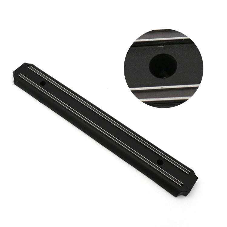 Black magnetic knife holder rail with long channel and round mounting hole detail.