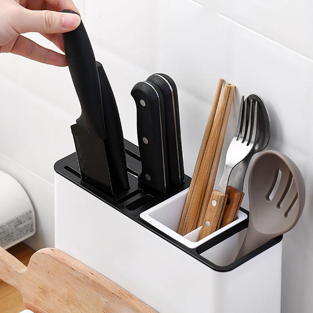 Black knife drawer organizer insert holding knives, forks, and wooden utensils inside a white rack