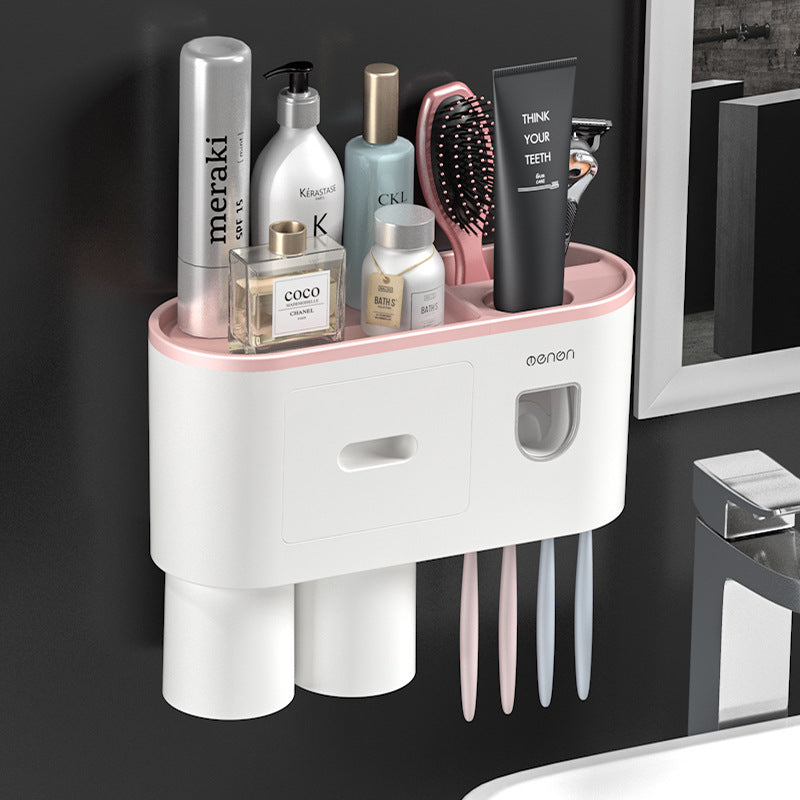 White toothbrush holder with pink rail, drawer panel, and slots for multiple toothbrush handles