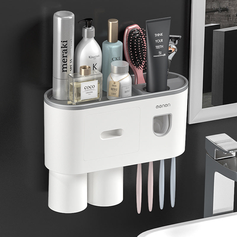 White wall-mounted toothbrush organizer with drawer front, cup holders, and toothbrush slots with cups.