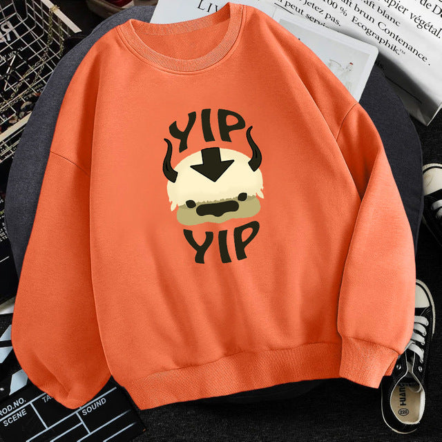 Orange fleece crewneck sweatshirt with centered character graphic print