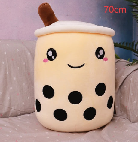 White plush bubble tea cup pillow with brown straw, smiling face and black dot accents