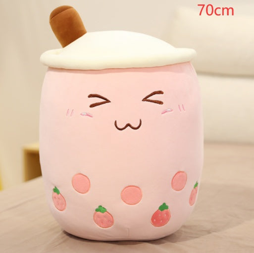 Large light pink boba plush pillow with white lid, tan straw, and strawberry print