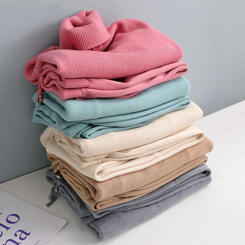 Folded knitted tracksuit sets in pink, teal, cream, beige, and gray colors