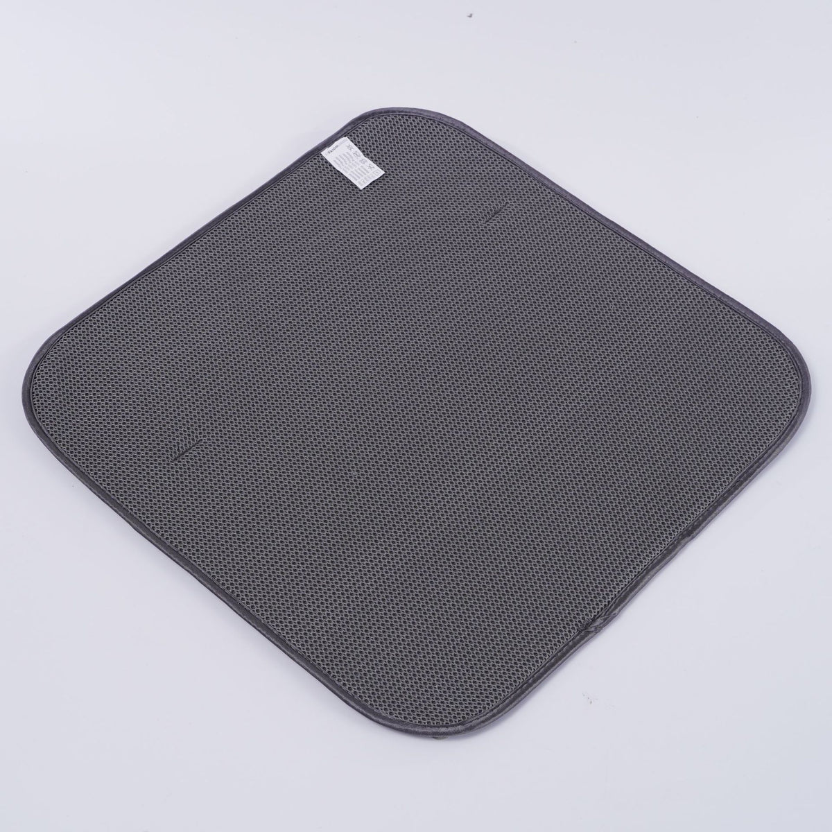 Gray perforated dish draining rack mat with rounded corners and stitched edge