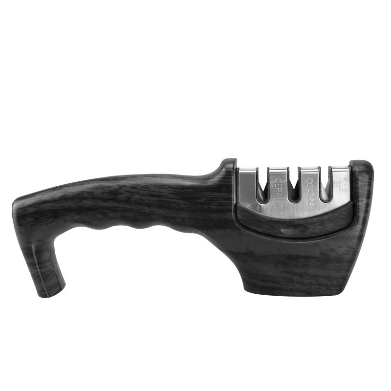Black handheld knife sharpener with silver sharpening slots and textured body