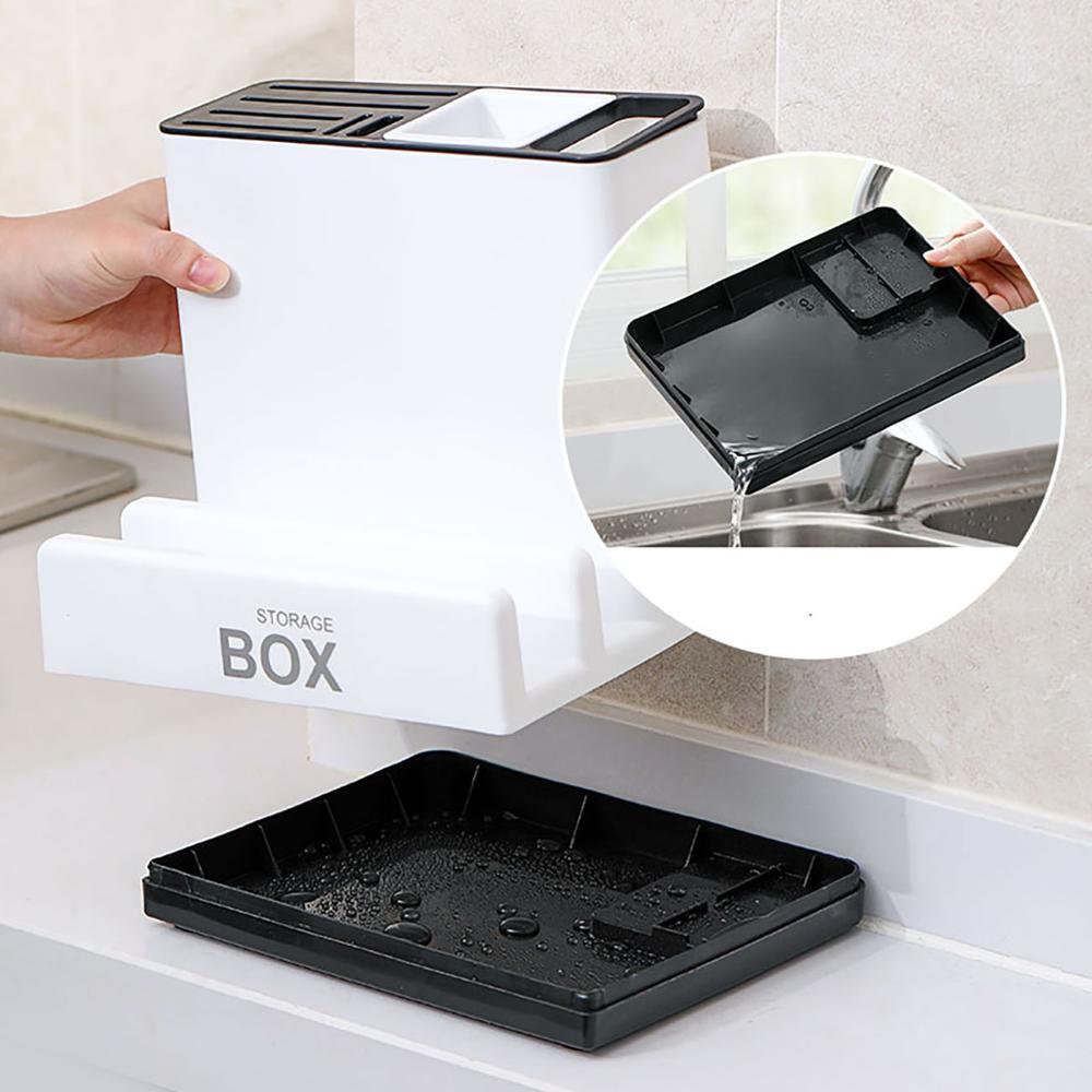 White knife drawer organizer in a drawer, with open storage box and slotted top tray