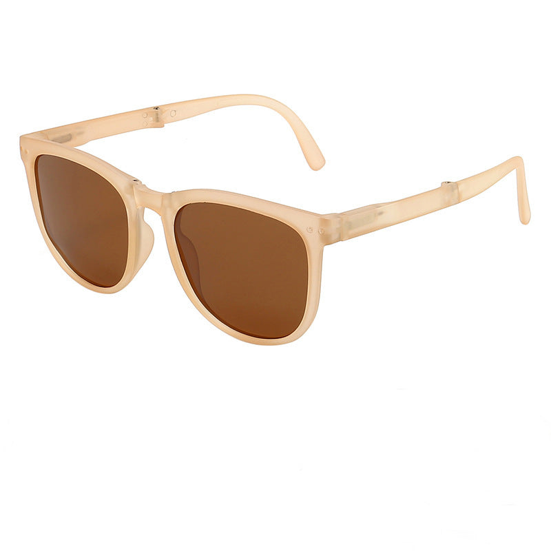 Foldable sunglasses with light beige frames and brown-tinted lenses