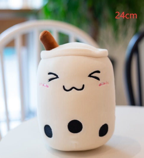 White plush boba tea cup pillow with brown straw, rosy cheeks, and dot pattern