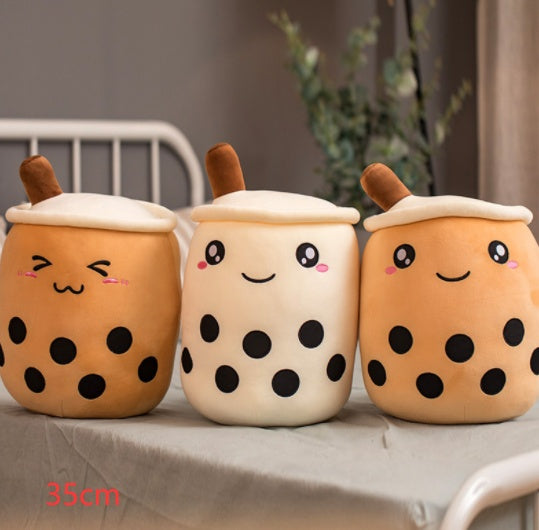 Set of three plush bubble tea cup pillows: tan, white, and tan with brown straws and smiling faces