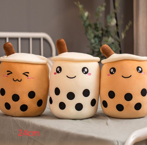Three plush boba drink cup pillows in tan and white with brown straws, cute faces, dot patterns