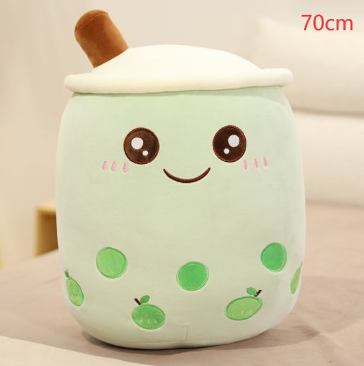 Mint green plush bubble tea cup pillow with brown straw, white lid, smiling face and green fruit dots