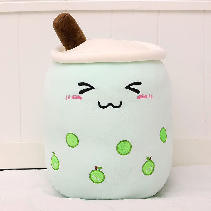 Mint green plush boba drink cup pillow with brown straw, white lid, smiling face and green bean dots