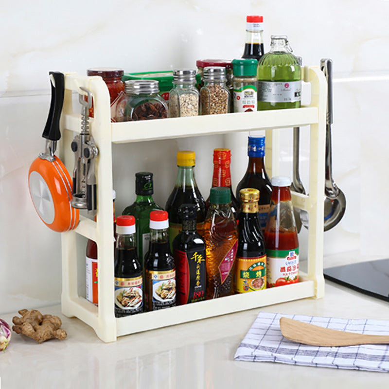 Cream kitchen storage rack with two shelves holding bottles and spice jars