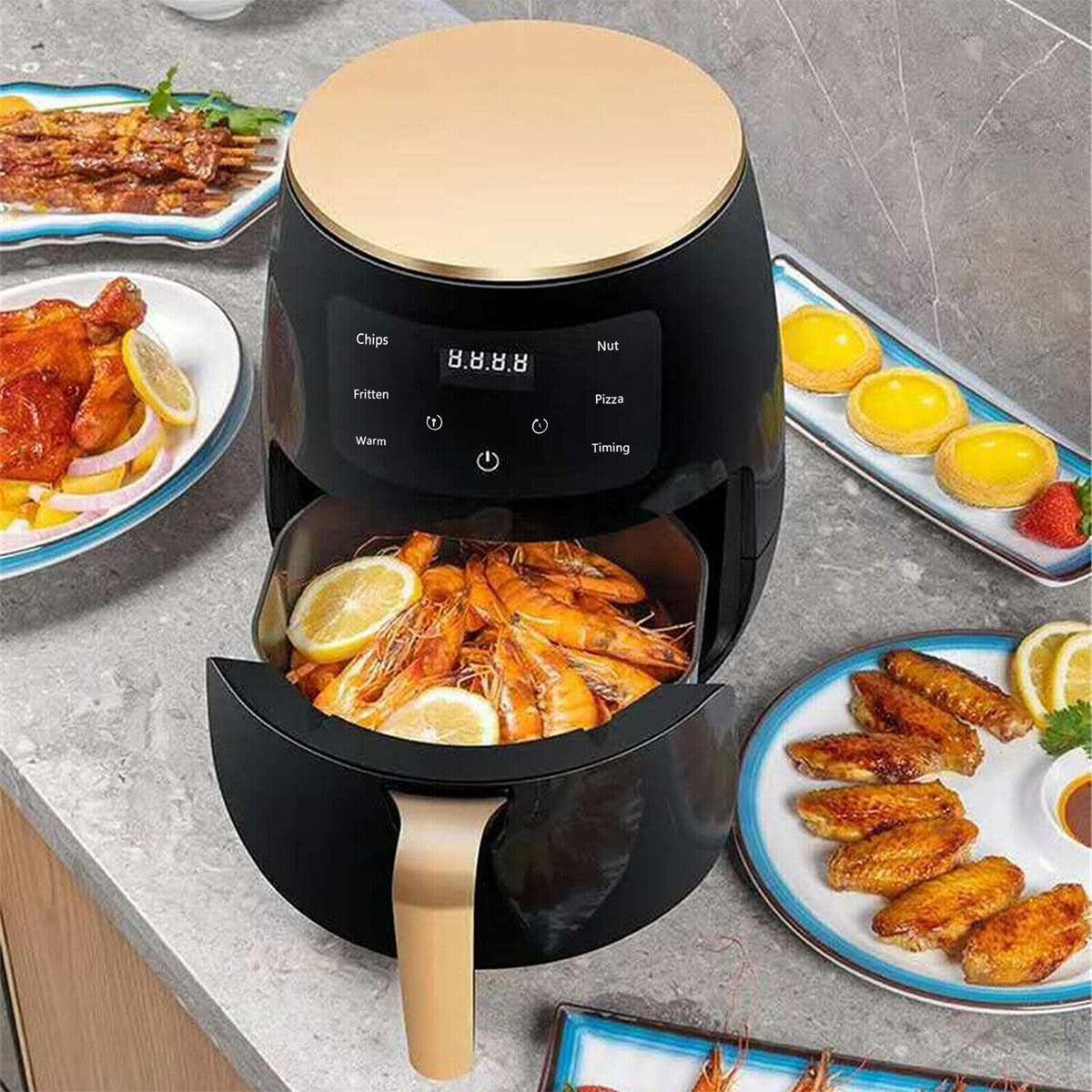 Black air fryer on countertop with open basket, shrimp, fries, and lemon