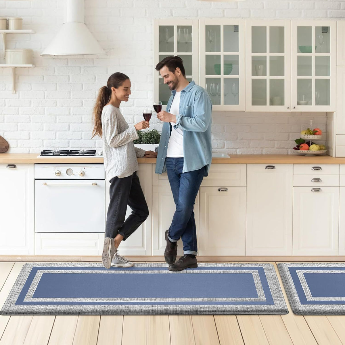 Marble-look kitchen floor mats in blue-gray with navy border strip