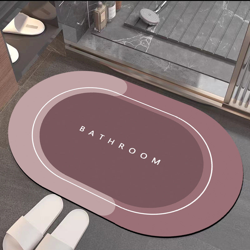 Quick-drying bathroom floor mat, mauve top with white border outline, close-up of ���BATHROOM���