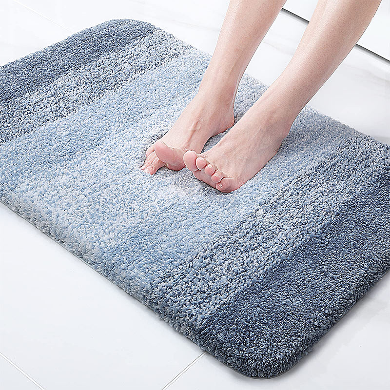 Blue absorbent floor mat with plush textured pile and rounded corners