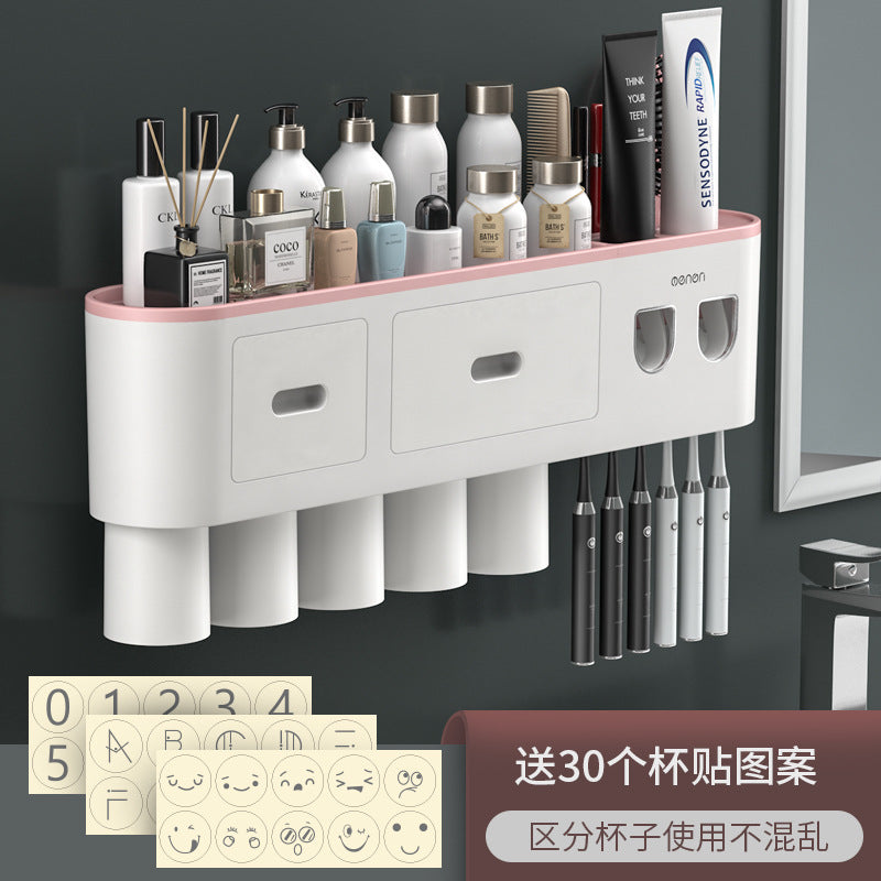 White wall-mounted toothbrush organizer with pink accent rim, two drawers, cup slots, and toothbrush holders.