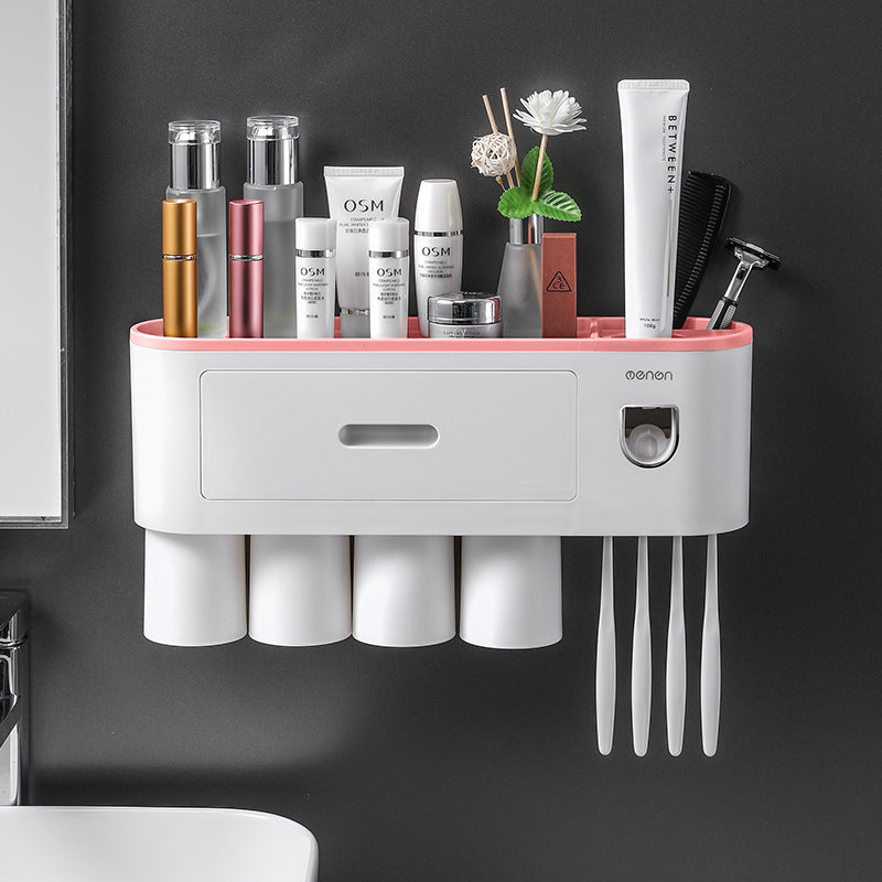 White toothbrush organizer with pink top rail, cup compartments, and brush handle slots
