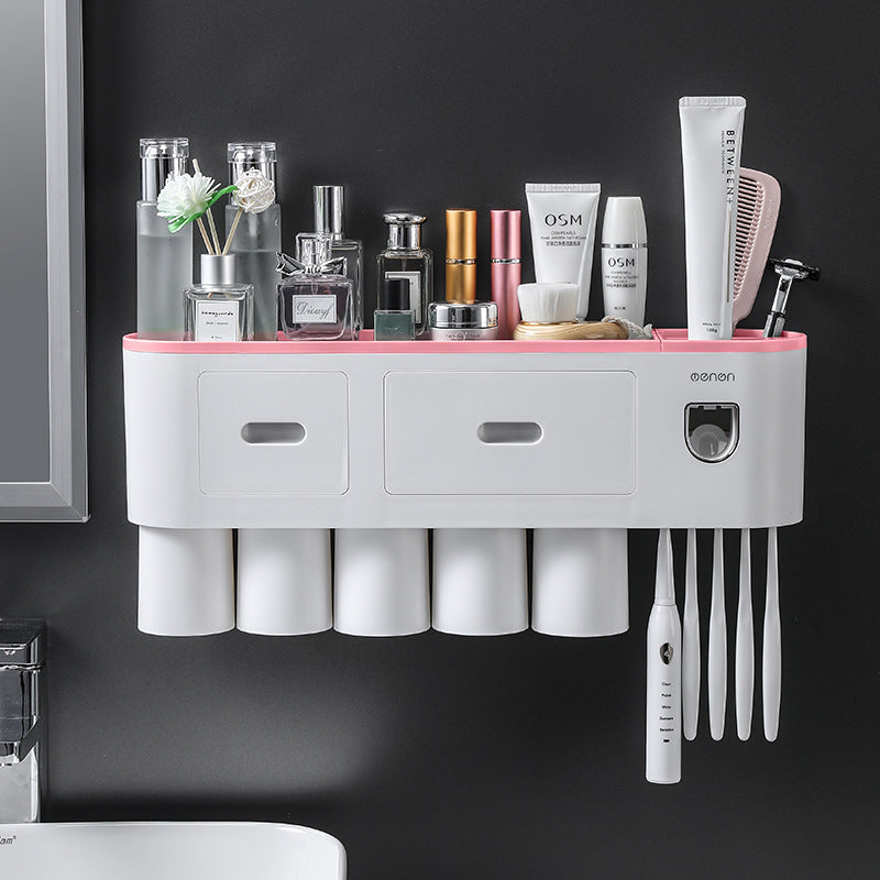 White toothbrush holder with pink top rail, multiple cup slots, and toothbrush storage comb slot