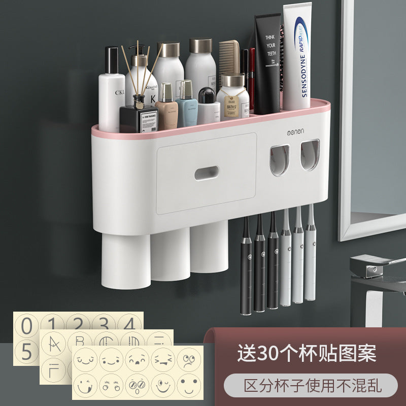 White toothbrush holder with pink top accent, brush slots, and two front drawers
