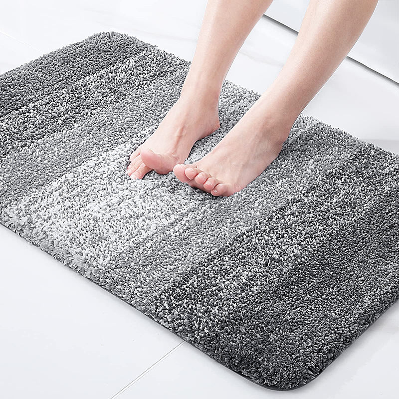Light gray absorbent floor mat with dense shag texture and rounded corners