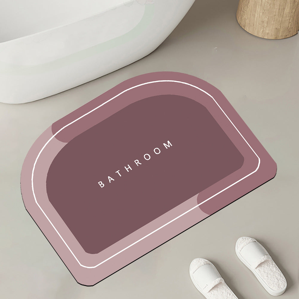 Quick-drying bathroom floor mat, mauve with white border outline, front view with ���BATHROOM��� text