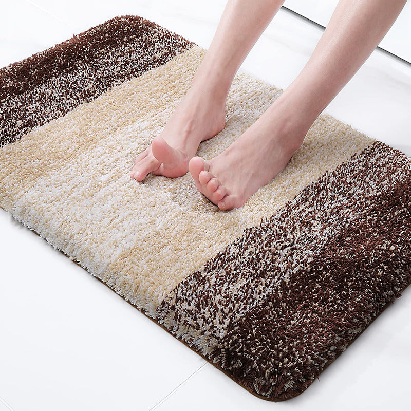 Gray absorbent floor mat with plush textured pile and rounded edge