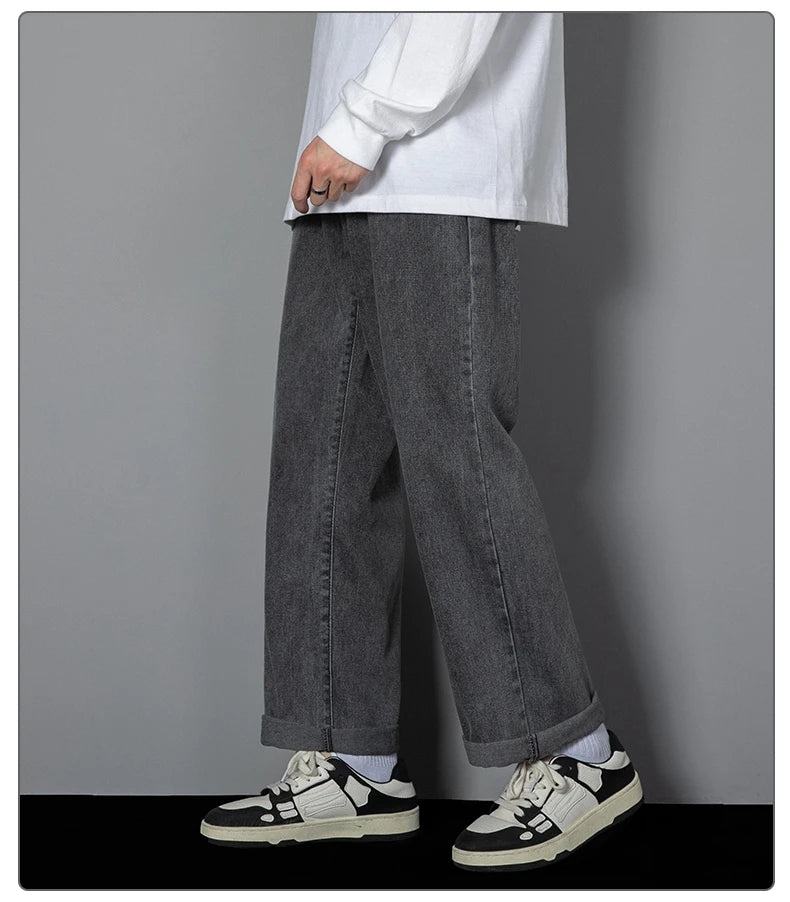Charcoal wide-leg denim jeans with relaxed straight legs and cuffed hem detail