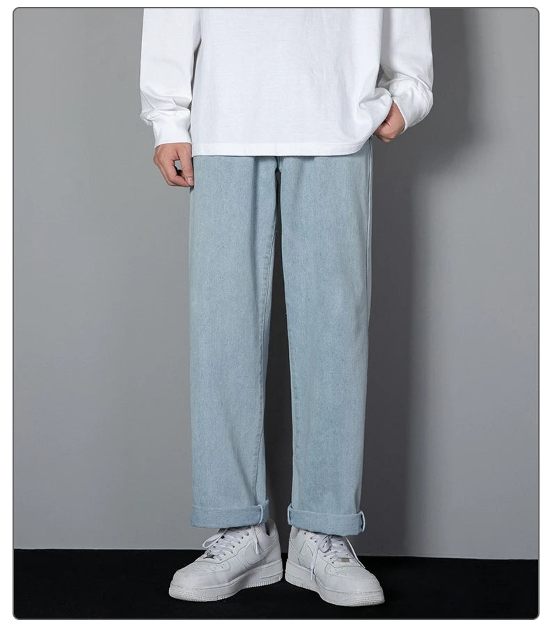 Wide-leg light wash denim jeans with relaxed straight cut and cuffed hems