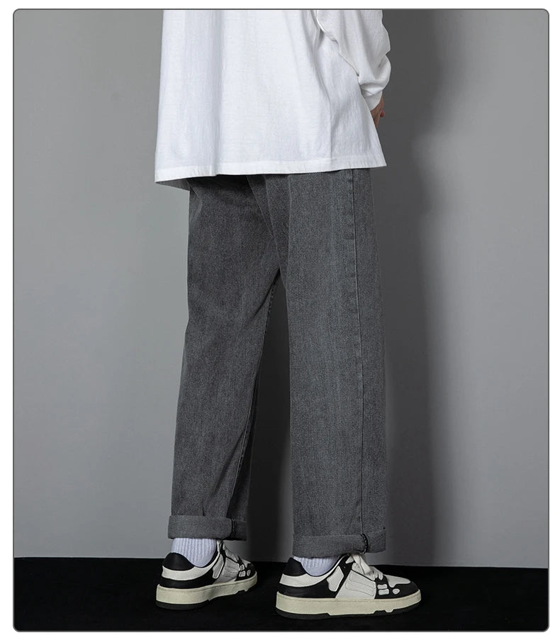 Wide-leg dark wash denim jeans, cuffed hem and roomy straight-leg silhouette