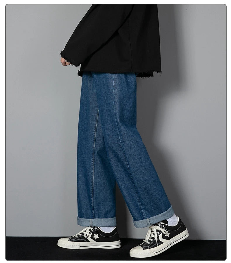 Mens wide-leg long jeans, medium blue denim, relaxed straight legs, cuff at ankle