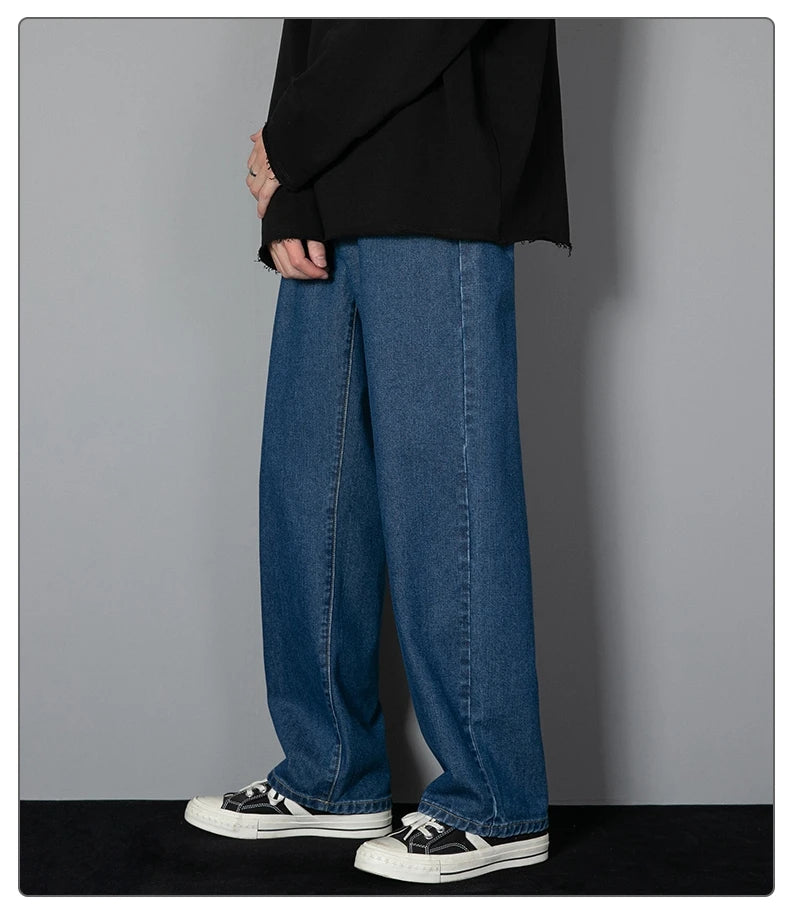 Mens wide-leg long jeans, medium blue denim, loose straight fit, stacked hems