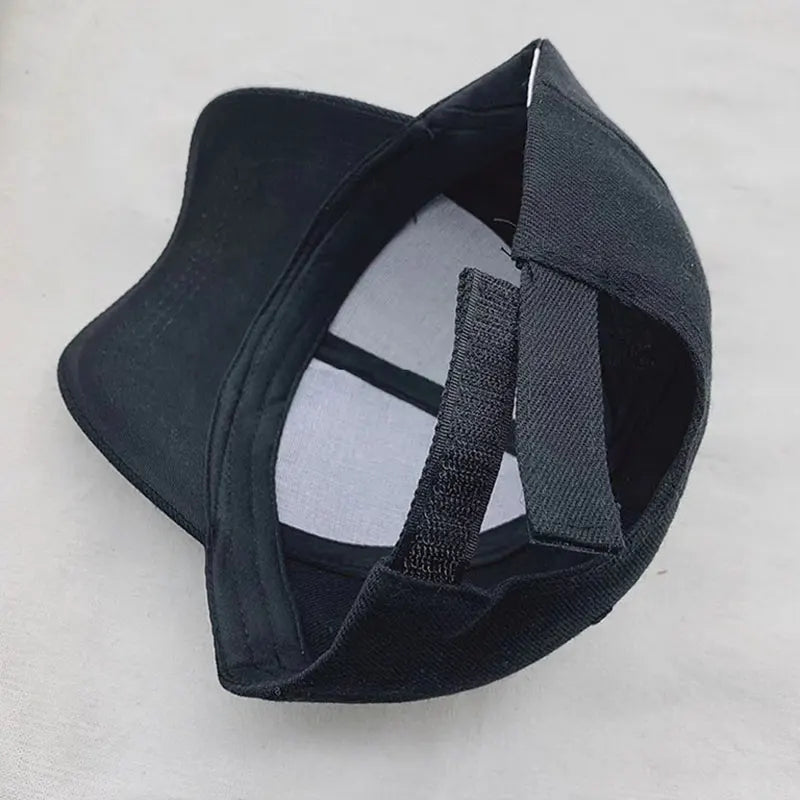 Solid color baseball cap, dark fabric; curved brim and side profile
