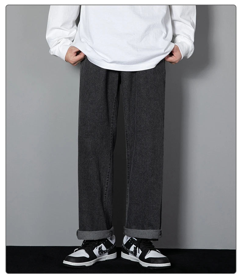 Wide-leg black denim jeans with relaxed straight fit and cuffed hems
