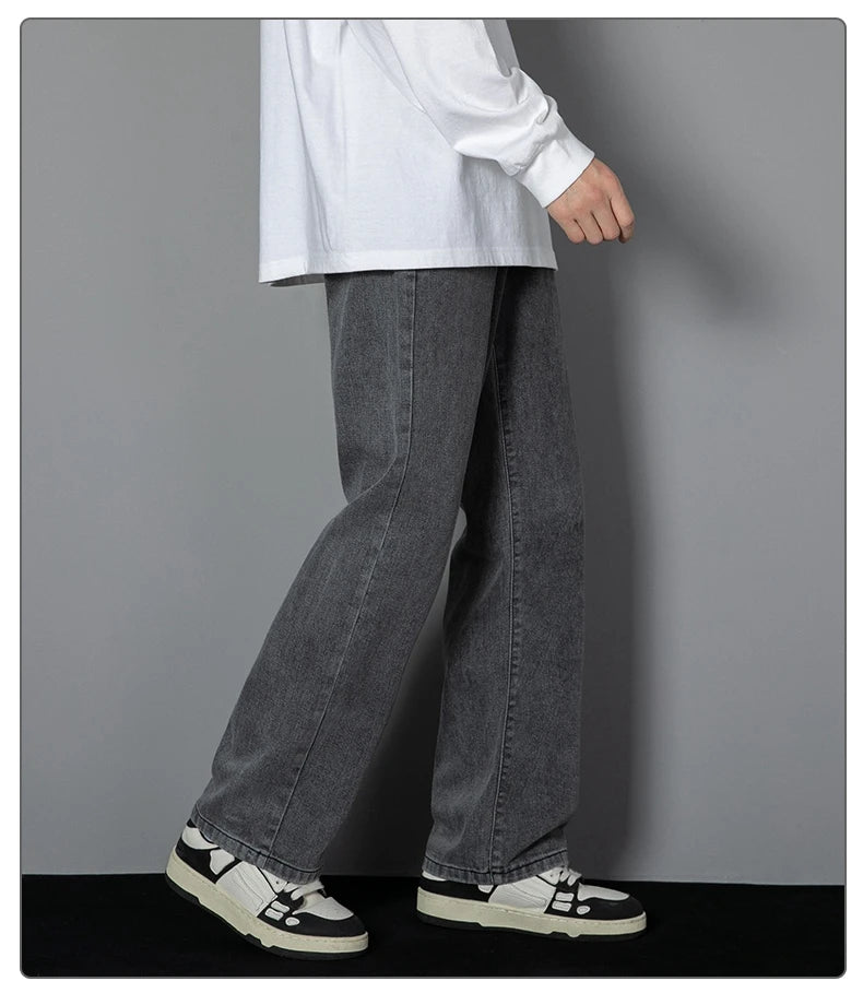 Wide-leg dark wash denim jeans with relaxed straight fit and stitched seams