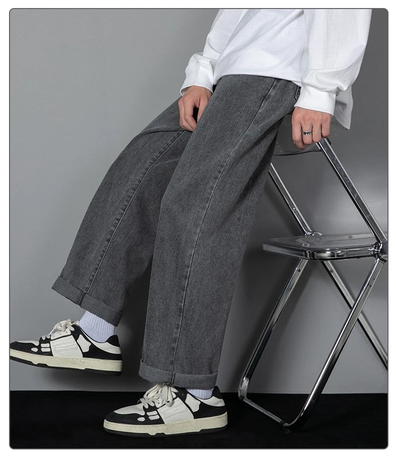 Wide-leg dark wash denim jeans with loose fit and visible side seam stitching
