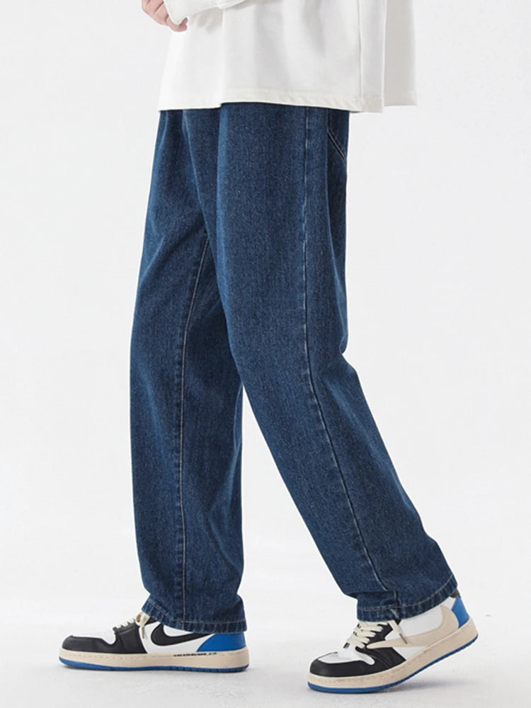 Dark blue wide-leg denim jeans, ankle-length, with straight seam lines