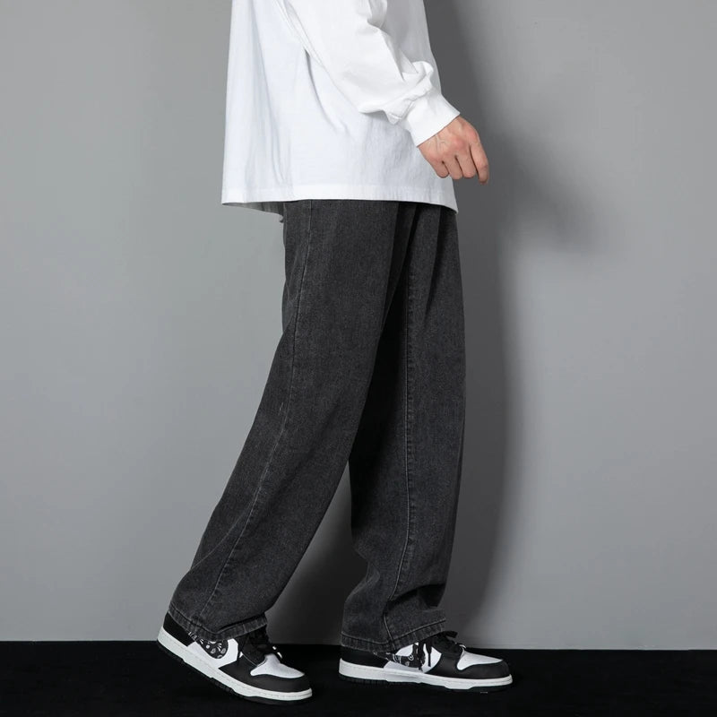 Dark wash wide-leg denim jeans with straight cut and cuffed hem, side seams visible