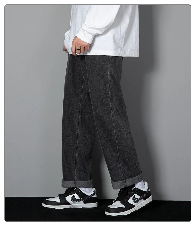 Wide-leg black denim jeans with loose straight silhouette and contrast stitching