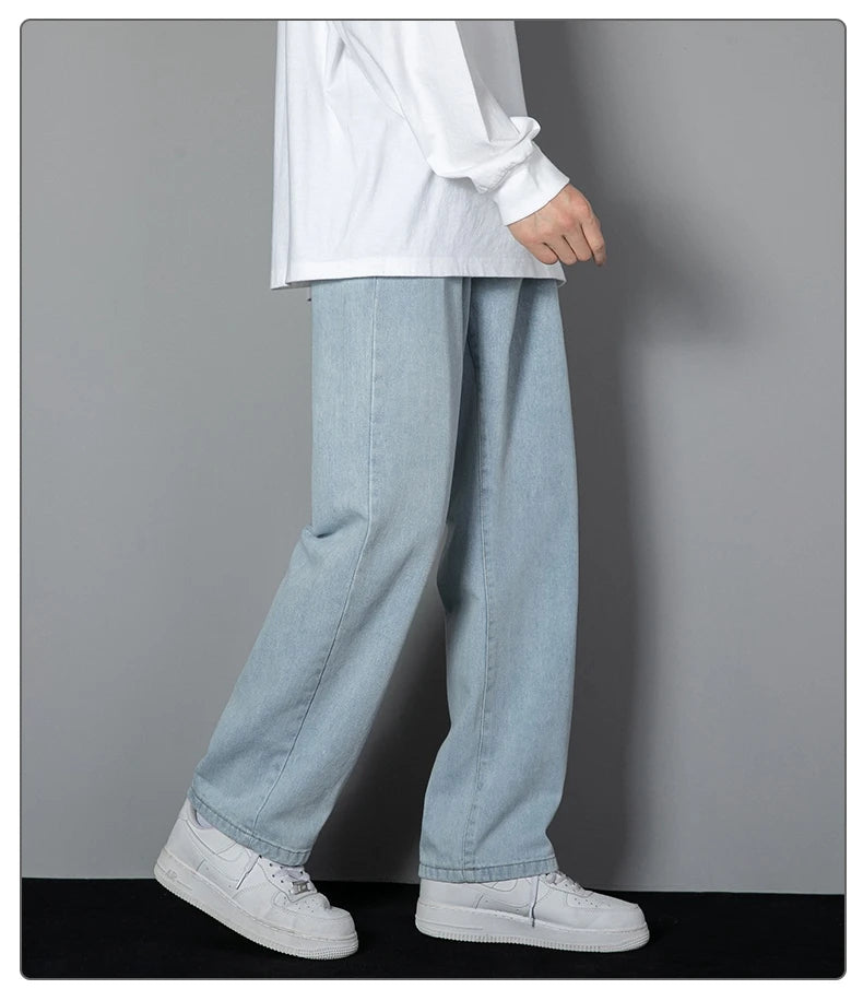 Wide-leg light wash denim jeans with roomy straight legs and stitched fly detail