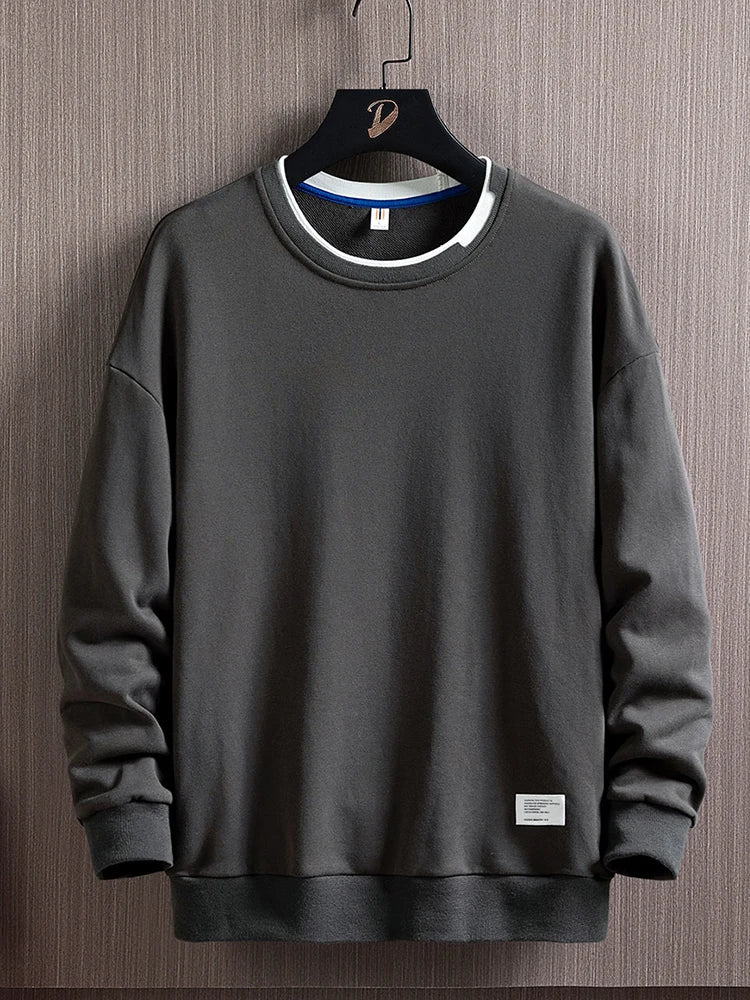 Men's dark gray round-neck pullover sweater with ribbed cuffs and hem