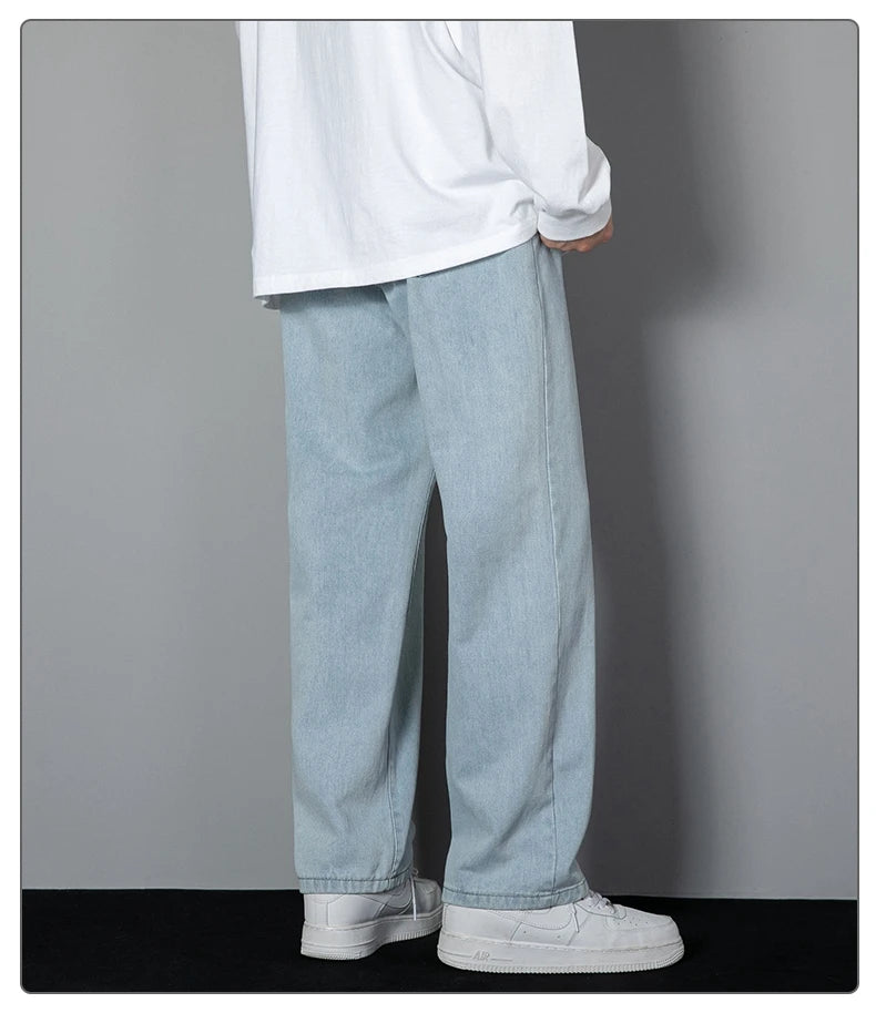 Wide-leg light wash denim jeans with relaxed straight leg and solid cuffed hem