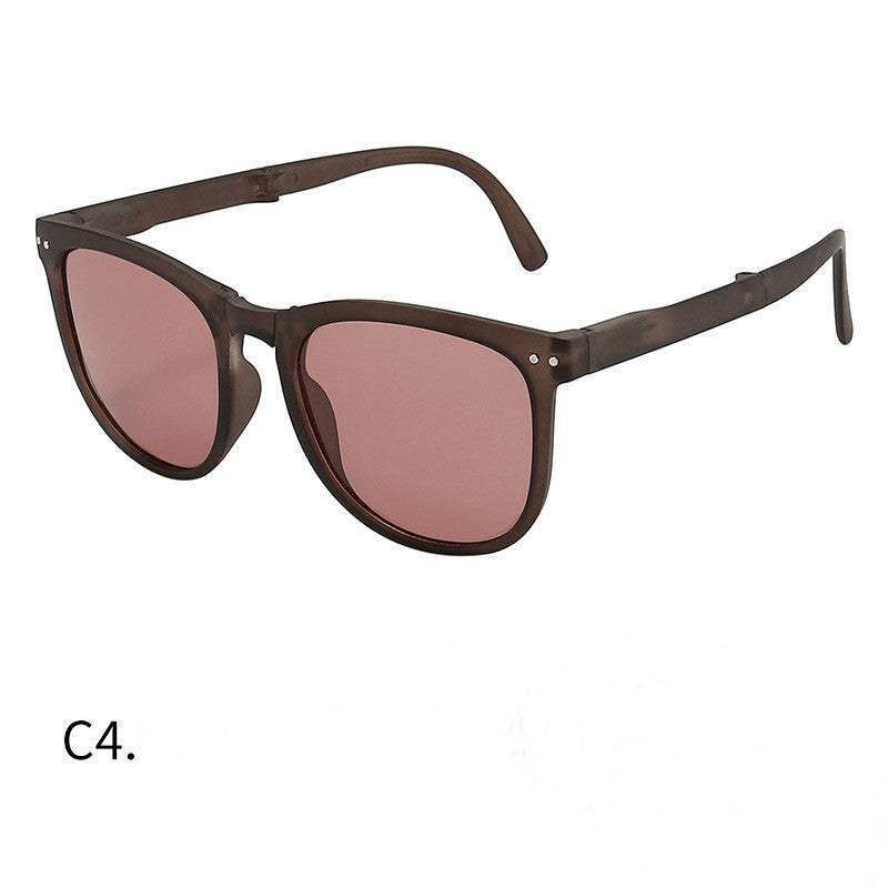 Foldable sunglasses with tortoiseshell frames and pink-tinted lenses