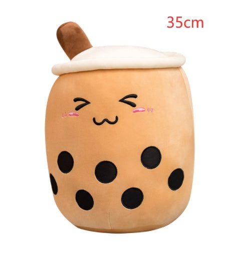 Brown boba drink plush pillow with white lid and tan straw, smiling face and black dots