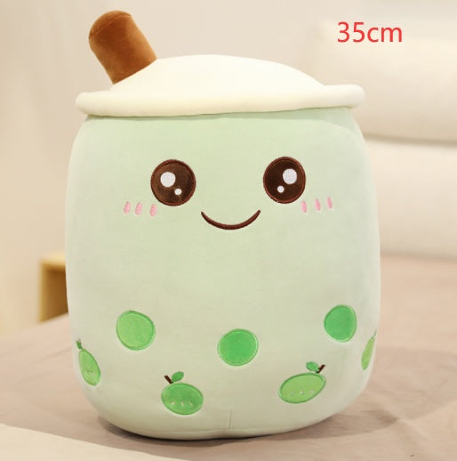 Mint green plush drink cup pillow with brown straw and white lid, smiling face and green fruit spots